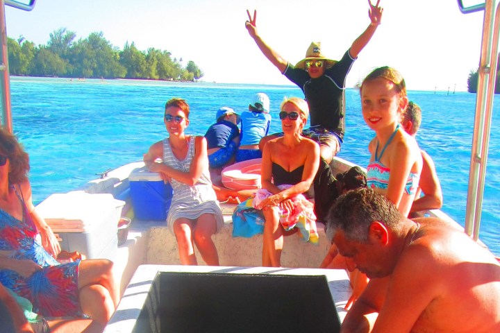 a group of people sitting at a beach